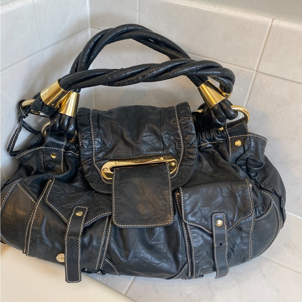 Dolce & Gabbana
Black Leather handbag with gold hardware 
good condition